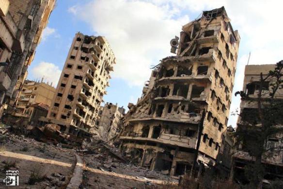 Citizen journalist image, provided by Lens Young Homsi, shows buildings destroyed by Syrian government bombing and shelling, in the Jouret al-Chiyah neighborhood of Homs, July 2013.