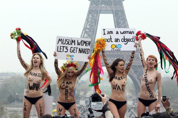 FEMEN objects to hijab and male oppression, with large phallic object behind