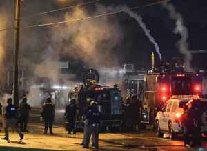 Pollice with armored personnel carriers fire tear gas at protesters, Ferguson, Missouri, August 17, 2014. Photo: Roberto Rodriguez/EPA